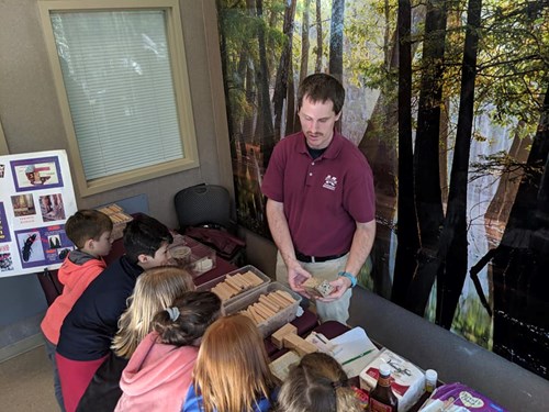 students with exhibitor at stem leaves and trees at mississippi museum of natural science